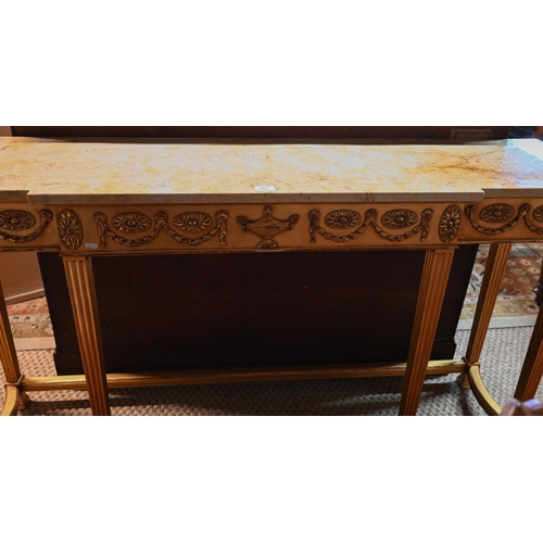 657 - An Adam style breakfront giltwood marble top console table, the frieze with floral swags in relief, ... 