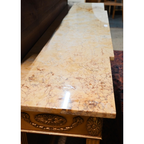 657 - An Adam style breakfront giltwood marble top console table, the frieze with floral swags in relief, ... 