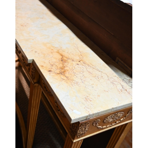 657 - An Adam style breakfront giltwood marble top console table, the frieze with floral swags in relief, ... 