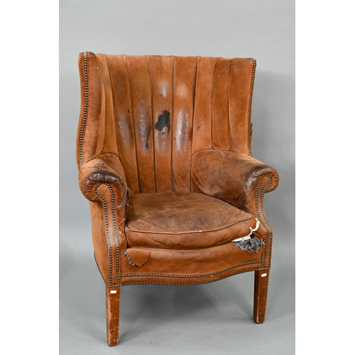 660 - A William IV style porters wing armchair, in battered studded suede and raised on square section fro... 