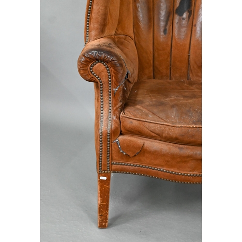 660 - A William IV style porters wing armchair, in battered studded suede and raised on square section fro... 