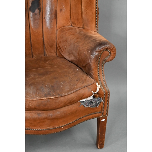 660 - A William IV style porters wing armchair, in battered studded suede and raised on square section fro... 