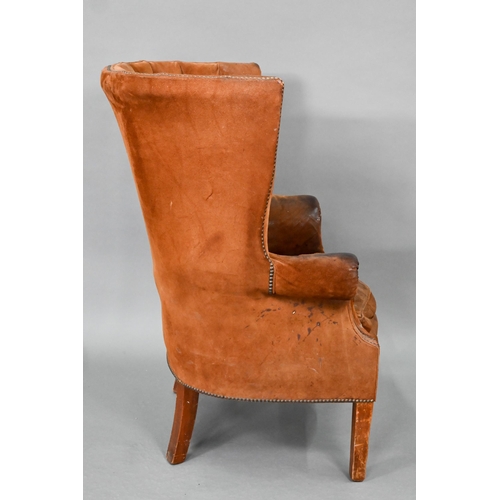 660 - A William IV style porters wing armchair, in battered studded suede and raised on square section fro... 