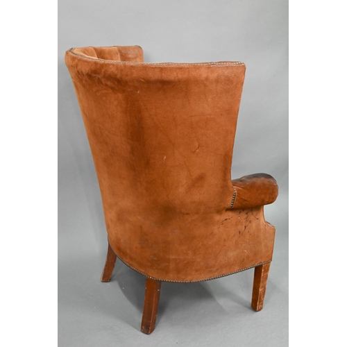 660 - A William IV style porters wing armchair, in battered studded suede and raised on square section fro... 