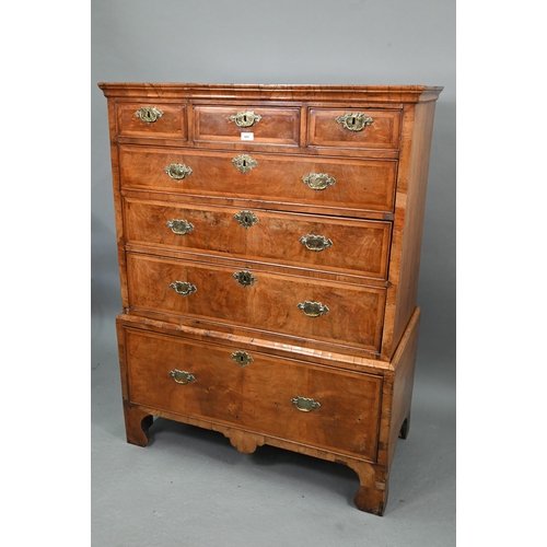 663 - A George I cross-banded walnut chest on stand, with three short over three long graduated drawers, t... 