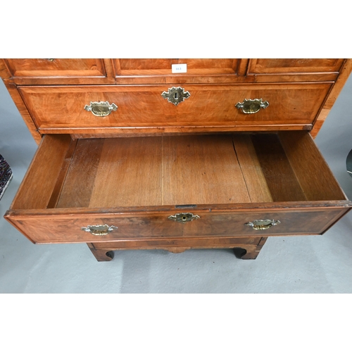 663 - A George I cross-banded walnut chest on stand, with three short over three long graduated drawers, t... 