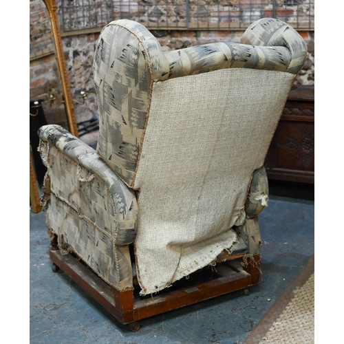 664 - A Foots of London, patent metamorphic reclining wingback armchairchair with integral two stage footr... 