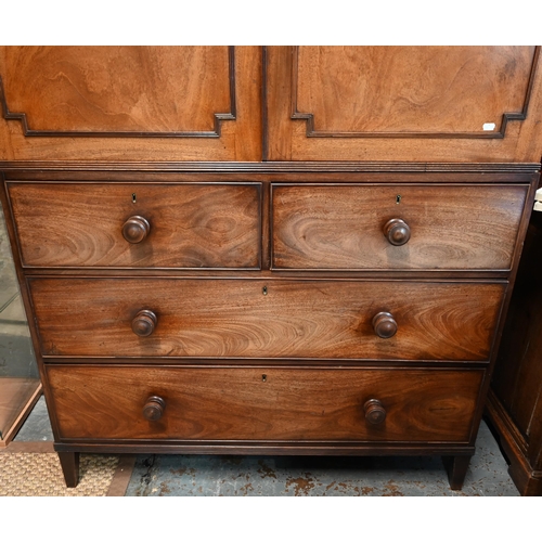 667 - A Victorian mahogany linen press, the moulded cornice over a pair of moulded panelled doors over two... 