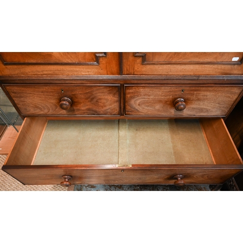 667 - A Victorian mahogany linen press, the moulded cornice over a pair of moulded panelled doors over two... 