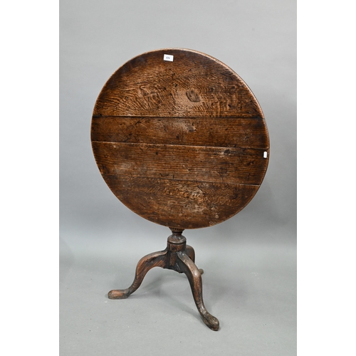 674 - An 18th century oak tripod table, the circular tilt top over a moulded support, 78 cm dia. x 70 cm h