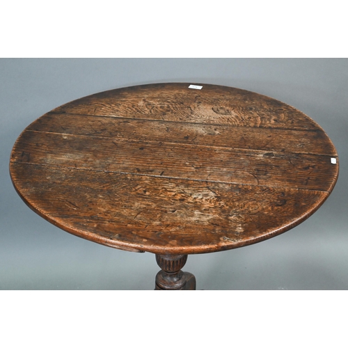 674 - An 18th century oak tripod table, the circular tilt top over a moulded support, 78 cm dia. x 70 cm h