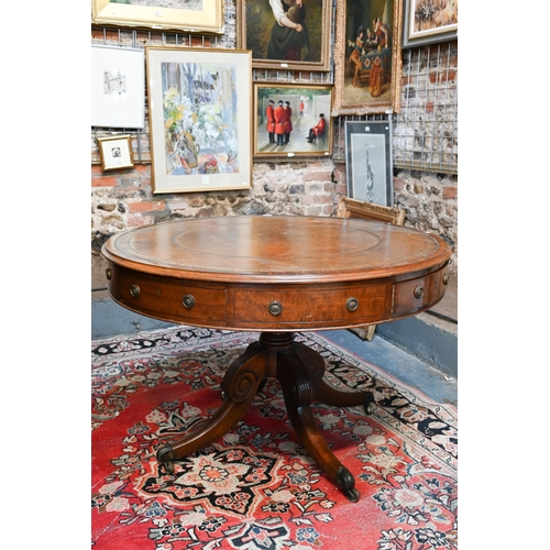 675 - A Victorian mahogany library drum table, the gilt tooled tan leather inset revolving top with four a... 