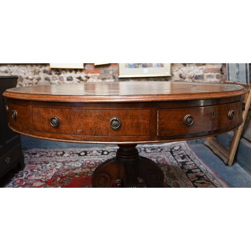 675 - A Victorian mahogany library drum table, the gilt tooled tan leather inset revolving top with four a... 