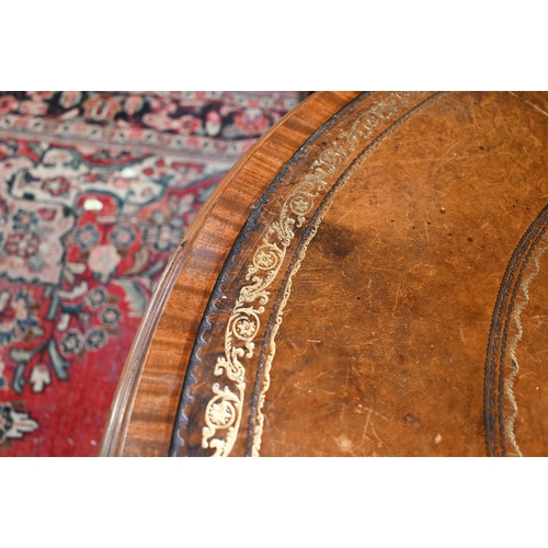 675 - A Victorian mahogany library drum table, the gilt tooled tan leather inset revolving top with four a... 