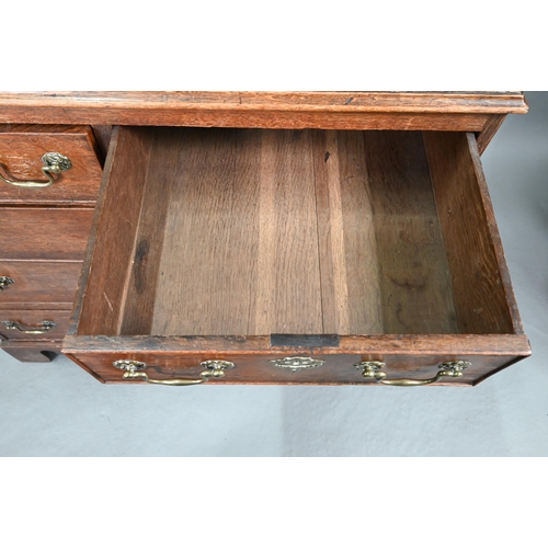 680 - An 18th century oak chest of two short over three long graduated cock-beaded drawers, with brass fit... 