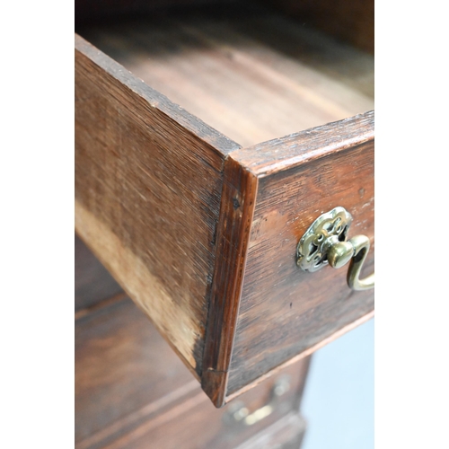 680 - An 18th century oak chest of two short over three long graduated cock-beaded drawers, with brass fit... 