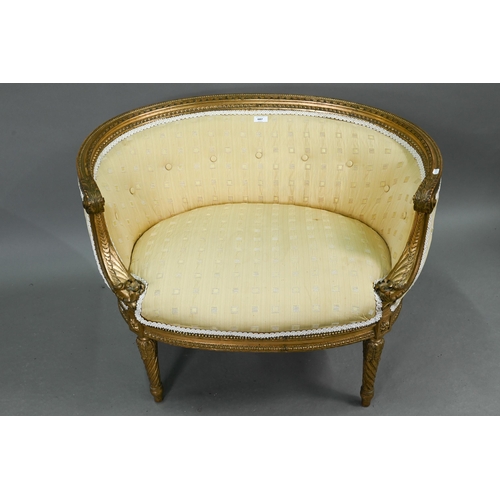 687 - A French giltwood framed, button back ochre silk upholstered salon window seat, raised on turned spi... 