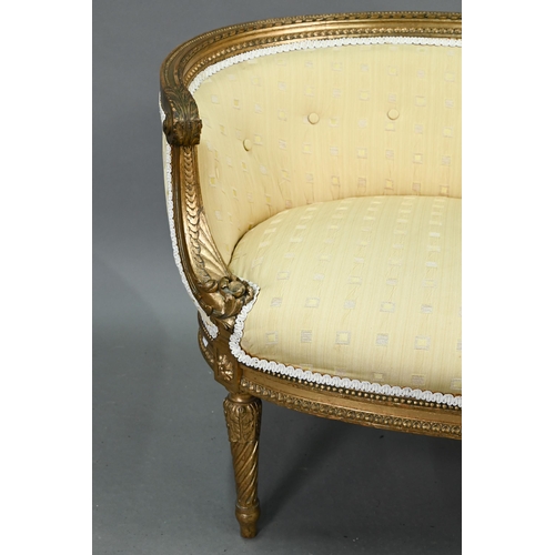 687 - A French giltwood framed, button back ochre silk upholstered salon window seat, raised on turned spi... 