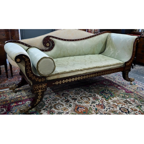 688 - A Regency profusely brass inlaid rosewood scroll end sofa, with pale green damask upholstery and rai... 