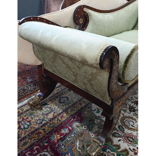 688 - A Regency profusely brass inlaid rosewood scroll end sofa, with pale green damask upholstery and rai... 