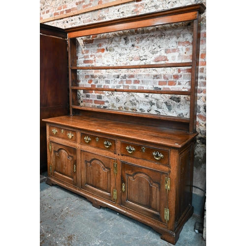 691 - An 18th century oak high dresser, the three tier associated open rack over three drawers and the arc... 