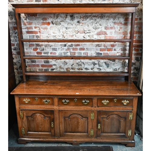 691 - An 18th century oak high dresser, the three tier associated open rack over three drawers and the arc... 