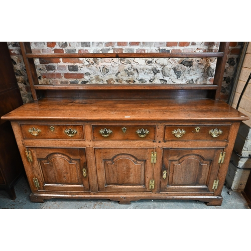 691 - An 18th century oak high dresser, the three tier associated open rack over three drawers and the arc... 