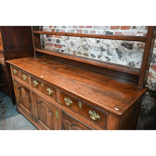 691 - An 18th century oak high dresser, the three tier associated open rack over three drawers and the arc... 