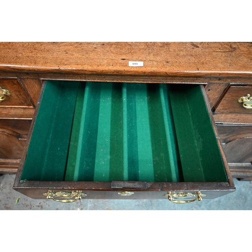 691 - An 18th century oak high dresser, the three tier associated open rack over three drawers and the arc... 