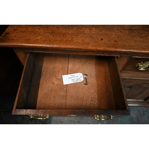 691 - An 18th century oak high dresser, the three tier associated open rack over three drawers and the arc... 