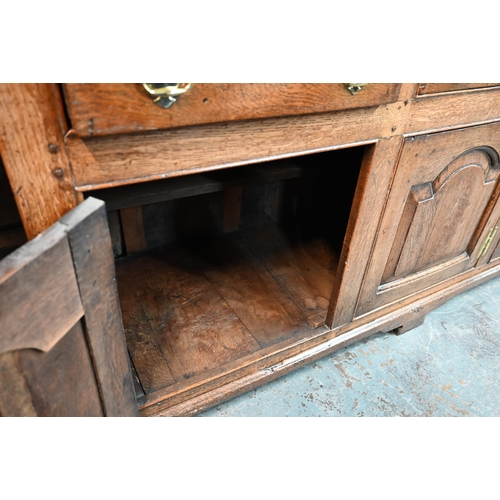 691 - An 18th century oak high dresser, the three tier associated open rack over three drawers and the arc... 