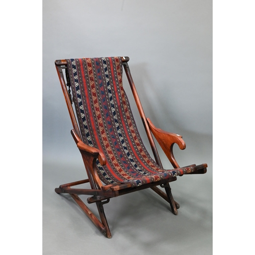 694 - An Afghan folding campaign chair, teak with steel mounts and a single spring action, fitted with a k... 