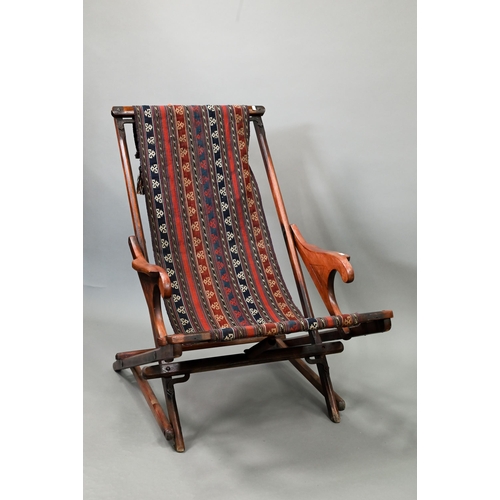 694 - An Afghan folding campaign chair, teak with steel mounts and a single spring action, fitted with a k... 