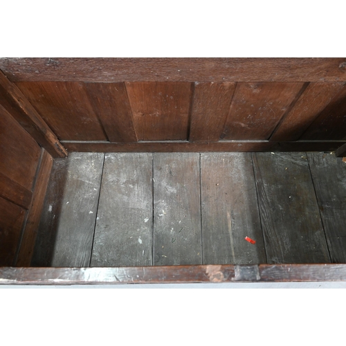 695 - A 17th century oak coffer, the wide two plank top over a lunette carved frieze and four diamond inci... 