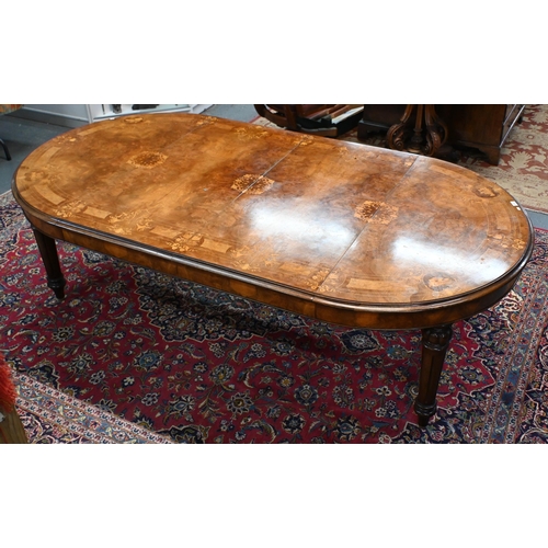 697 - A late 19th century inlaid walnut wind-out dining table, the rounded end top with two wide occasiona... 