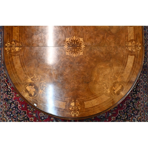 697 - A late 19th century inlaid walnut wind-out dining table, the rounded end top with two wide occasiona... 