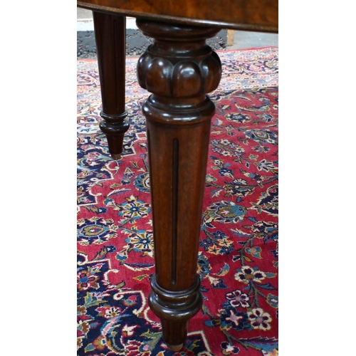 697 - A late 19th century inlaid walnut wind-out dining table, the rounded end top with two wide occasiona... 