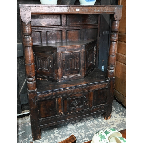 699 - A 17th century oak court cupboard, the recessed canted sided upper cupboard with arcaded moulded pan... 