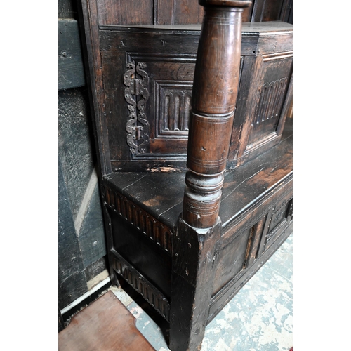 699 - A 17th century oak court cupboard, the recessed canted sided upper cupboard with arcaded moulded pan... 