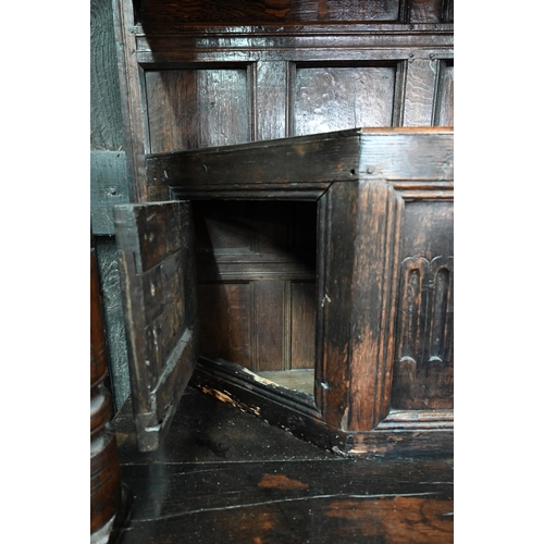 699 - A 17th century oak court cupboard, the recessed canted sided upper cupboard with arcaded moulded pan... 