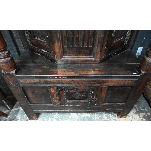 699 - A 17th century oak court cupboard, the recessed canted sided upper cupboard with arcaded moulded pan... 