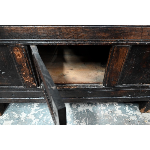 699 - A 17th century oak court cupboard, the recessed canted sided upper cupboard with arcaded moulded pan... 