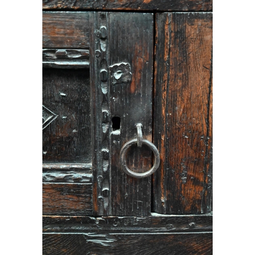 699 - A 17th century oak court cupboard, the recessed canted sided upper cupboard with arcaded moulded pan... 