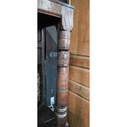 699 - A 17th century oak court cupboard, the recessed canted sided upper cupboard with arcaded moulded pan... 