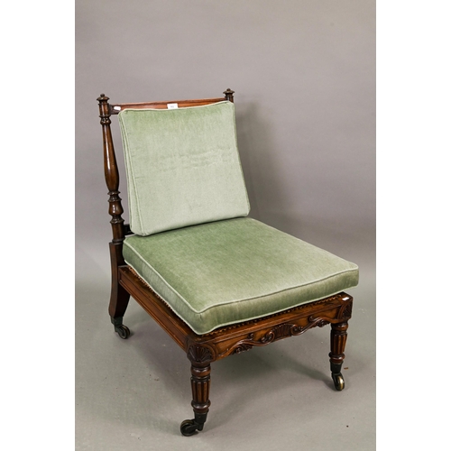 701 - A Regency rosewood bergere seat campaign chair, with moulded frieze and raised on gadrooned front le... 