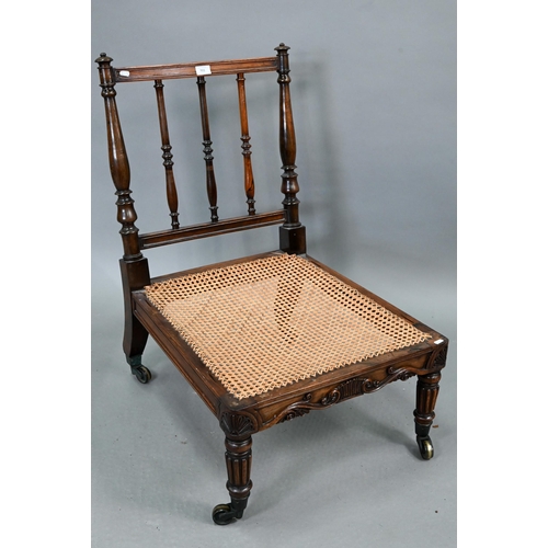 701 - A Regency rosewood bergere seat campaign chair, with moulded frieze and raised on gadrooned front le... 