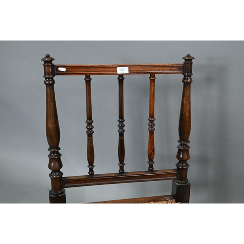 701 - A Regency rosewood bergere seat campaign chair, with moulded frieze and raised on gadrooned front le... 