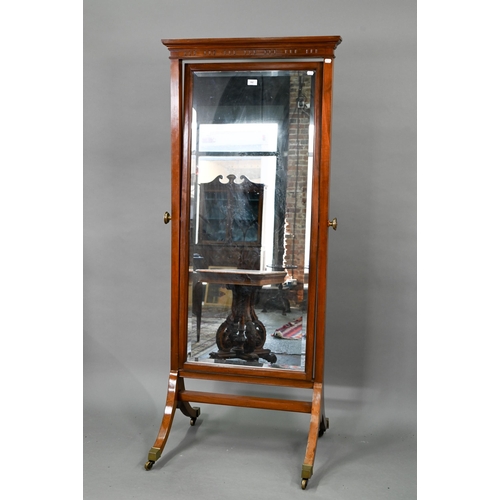 702 - An Edwardian red walnut framed cheval dressing mirror, with rectangular bevelled plate, raised on br... 