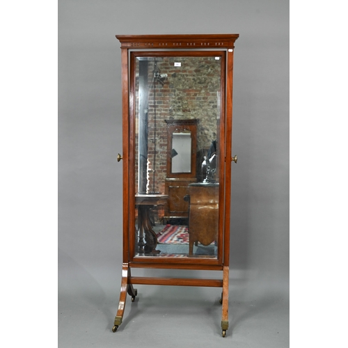 702 - An Edwardian red walnut framed cheval dressing mirror, with rectangular bevelled plate, raised on br... 