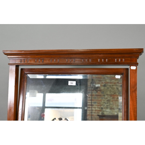 702 - An Edwardian red walnut framed cheval dressing mirror, with rectangular bevelled plate, raised on br... 